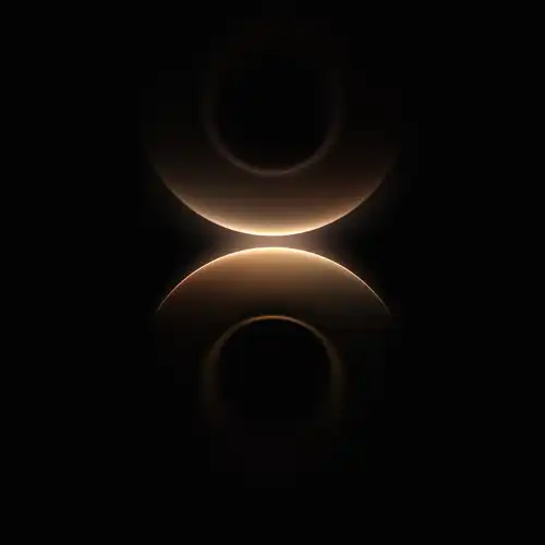Huawei Mate 80 wallpaper with warm golden circular glow on black background